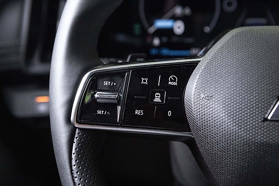 Steering wheel controls for cruise and safety assist features.