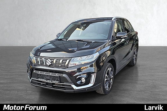 Stilren svart SUV med skinnende kromdetaljer og moderne grill.