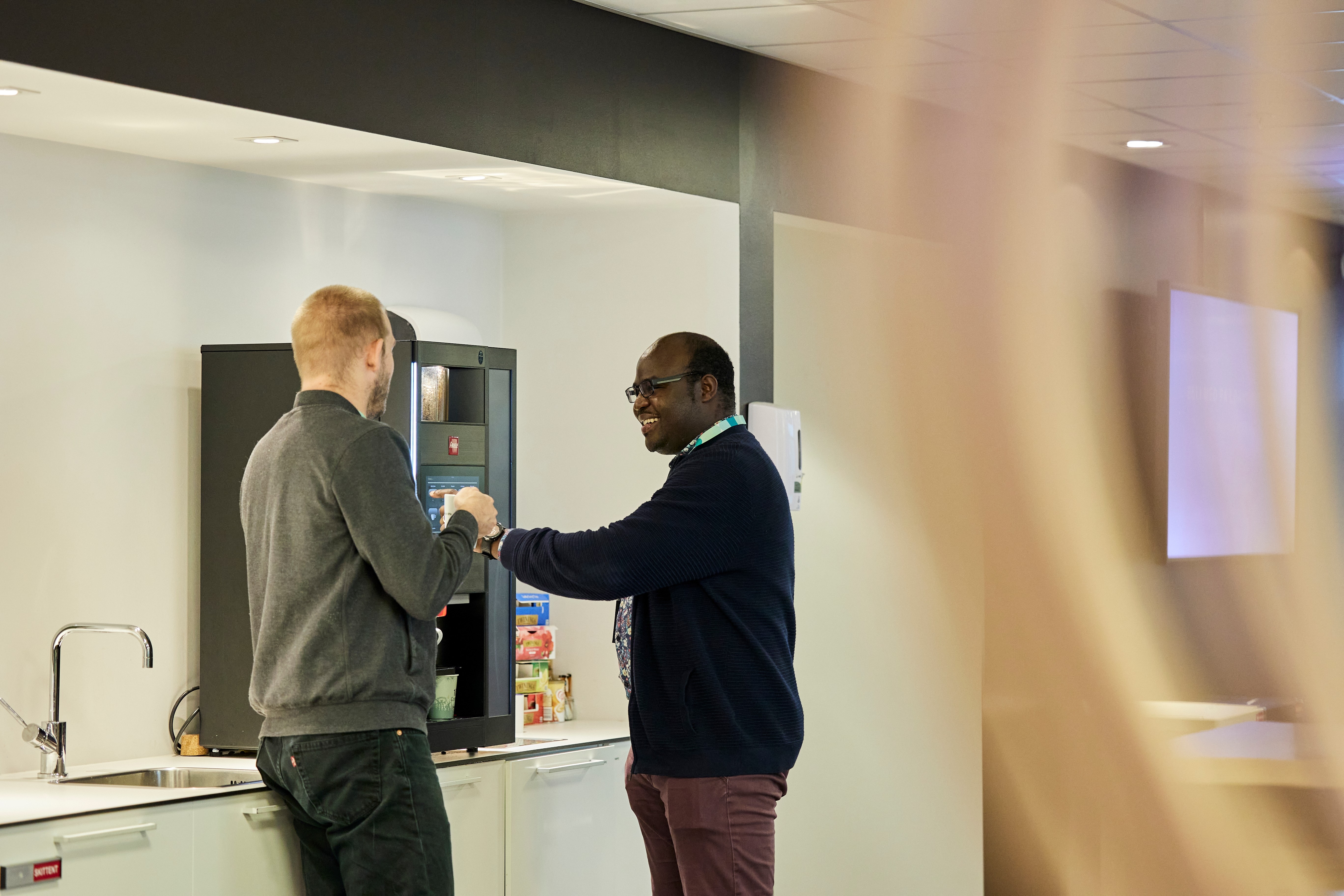 Kollegaer ved kaffemaskinen